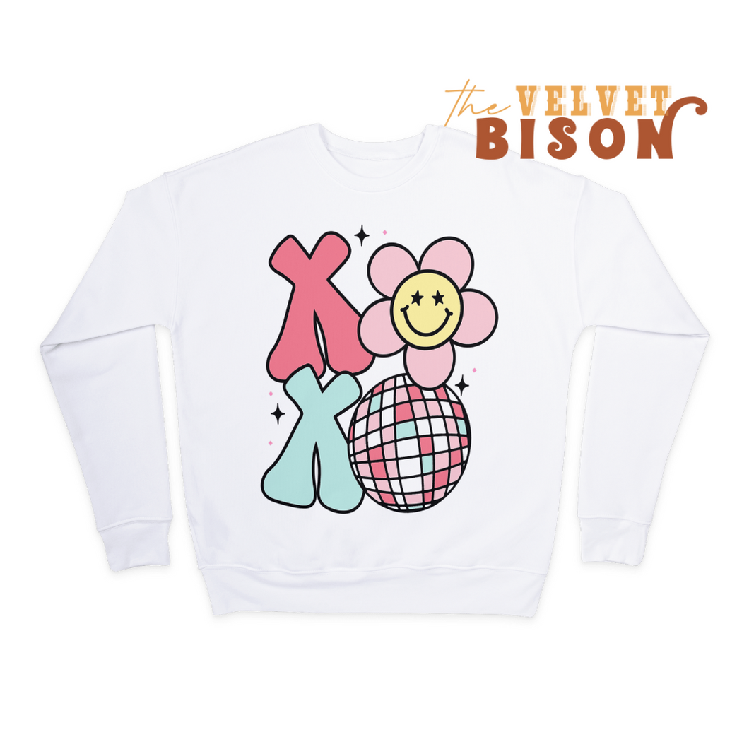 white sweater with xoxo graphic featuring daisies and disco balls